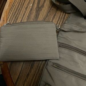 A large gray baggallini purse with attached coin purse. It has card holder.